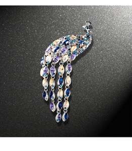 Detailed close-up of multi-colored crystals and silver peacock brooch craftsmanship