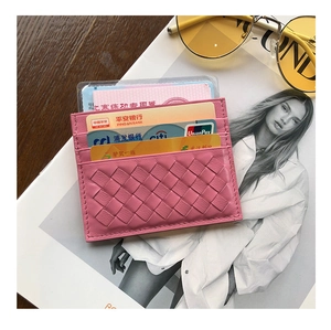 Detail of pink woven leather card holder with multiple slots and classic texture