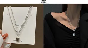 Detail of silver padlock pendant on a split-chain necklace with bead and link styles