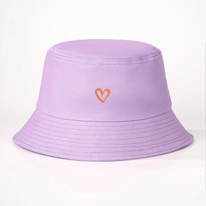 Detailed close-up of light purple cotton bucket hat with orange heart embroidery