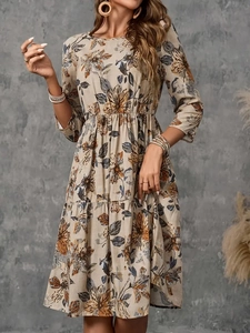 Detail of bohemian floral print and breathable linen texture on a mid-length dress