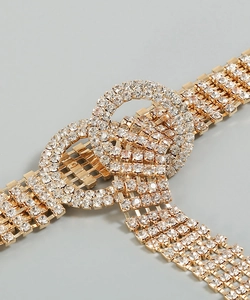 Macro view of a luxury gold waist chain with crystal rhinestones and double ring buckle