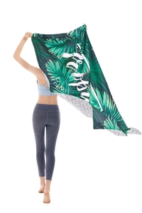 Microfiber beach towel with tropical palm leaves and geometric patterns on back