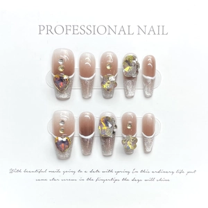Detail of pink and silver gradient press-on nails with luxury rhinestones and 3D floral accents