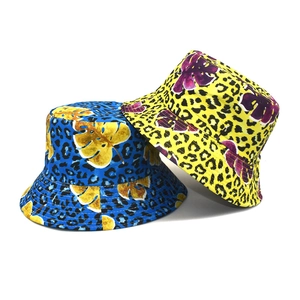 Autumn leopard print bucket hat featuring tropical leaf patterns in blue and yellow