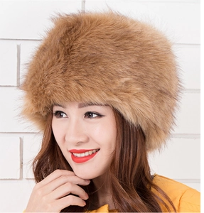 Detail view of thick brown faux fox fur hat showing plush texture and winter warmth