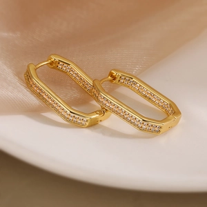 Detail view of gold-plated geometric earrings with micro-pave cubic zirconia crystals