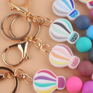 Macro detail of colorful silicone hot air balloon keychains with golden metal clasp