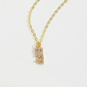 Close-up of gold chain necklace with BFF letter pendant featuring sparkling rhinestone details