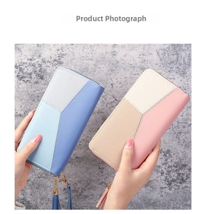 Detail of multi-color long zip wallets with metal tassels in blue and pink tones