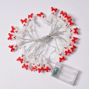 Macro detail of Christmas reindeer LED string lights with festive red bow decoration