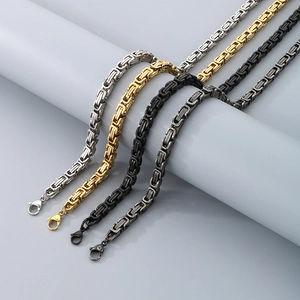 Detail of masculine Byzantine king chain necklaces in silver, gold, and black finishes