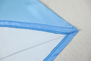 Macro shot of precise stitching and hem detail on the gradient halter maxi dress