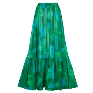 Detail of green and blue ink print maxi skirt with tiered hem and pleated texture