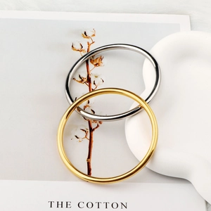 Minimalist 18k gold and silver 4mm stainless steel bangles with a polished mirror finish