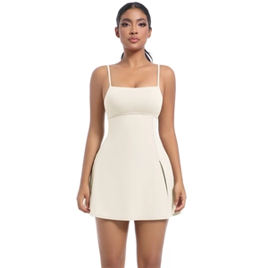 Detail of cream white tennis dress featuring spaghetti straps and side pleated skirt