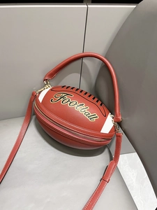 Detail of reddish-brown rugby shaped handbag with white stripes and zipper closure