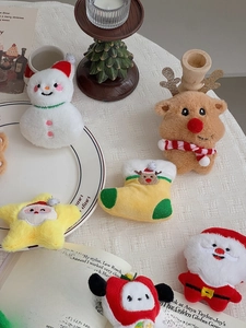 Detailed view of assorted Christmas plush charms including reindeer, snowman and Santa