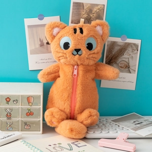 Détail d'une trousse chat en peluche orange avec fermeture éclair rose sur un bureau