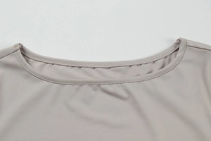 Detailed close-up of the elegant boat neckline with professional double-needle stitching