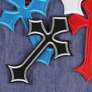 Gothic cross embroidery patches in black, red, blue, and white colors on denim fabric