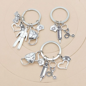 Close-up of medical themed keychains featuring ambulance, syringe, and stethoscope charms