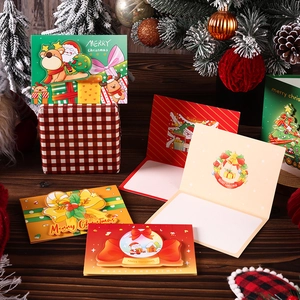 Detailed 3D pop-up Christmas cards featuring Santa and reindeer on a rustic wooden table