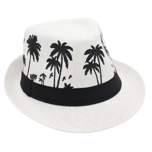 Detail of white straw fedora featuring black coconut tree embroidery and ribbon