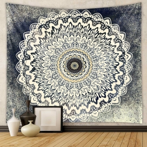 Detail of blue Bohemian mandala tapestry on light wall with ceramic decor and wood floor