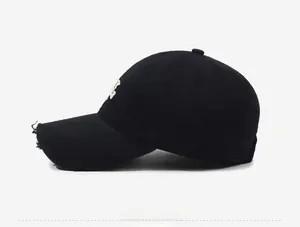 Close-up of distressed brim details and white embroidery on a black baseball cap