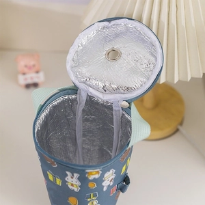 Detail of blue cartoon bunny insulated cup sleeve showing silver foil lining and handle