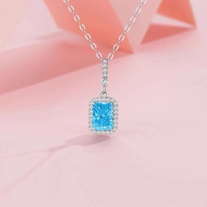 Elegant S925 silver necklace with square blue stone pendant on pink geometry background