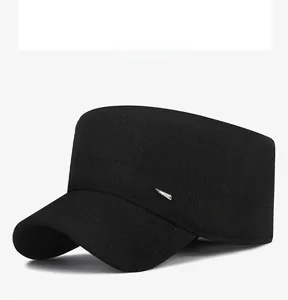 Detail view of the black wool cadet cap showing the flat top and side metal tag decoration