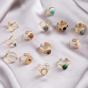 Bohemian vintage gold rings with turquoise and semi-precious stones on silk fabric