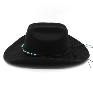 Detail of black wool felt cowboy hat featuring turquoise beads and tassel decoration