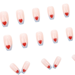 Minimalist nude and blue French tip press-on nails with red heart patterns