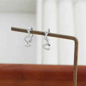 Detailed close-up of S925 sterling silver snake earrings with intricate scale texture