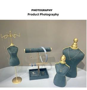 Deep teal velvet jewelry display set featuring mannequin busts and golden T-bar stand