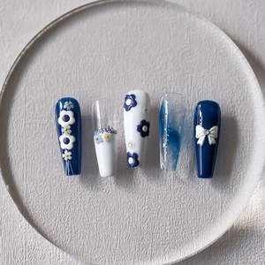 5D embossed nail stickers featuring blue floral designs and 3D white bowknot accents