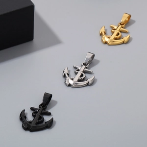 Detailed view of anchor shaped pendants in gold silver and black stainless steel colors