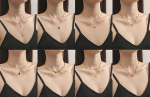 Close-up of various gold-plated stainless steel layered necklaces and heart pendants