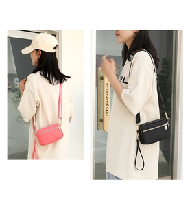 Dual view of compact multi-compartment shoulder bags in black and pink with adjustable straps