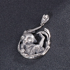 Detailed close-up of a silver stainless steel cat pendant with embossed leaf motifs