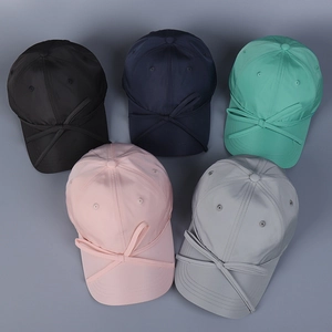 Detailed overhead view of five satin baseball caps with elegant bows in various pastel colors