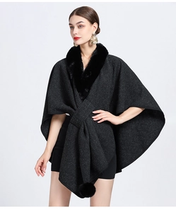 Detail showing the faux fur collar and decorative pom-pom on the dark grey knitted shawl