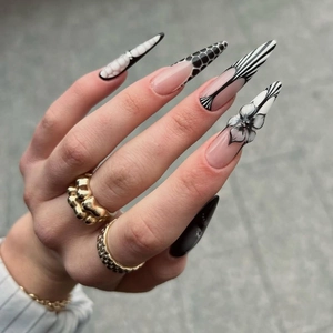 3D floral black and white stiletto press-on nails with avant-garde French almond design
