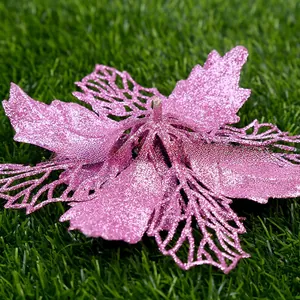 Detail of pink glitter poinsettia flower with hollow petals for Christmas tree decoration