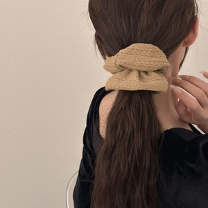 French vintage beige knit scrunchie with geometric patterns worn by a model