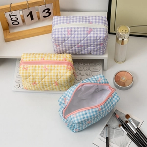 Quilted plaid makeup bag with bow pattern and zipper closure in three pastel colors