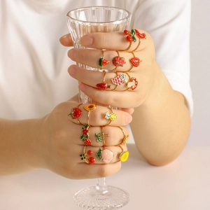 Colorful fruit enamel adjustable rings set in gold finish worn on hands with glass